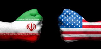 Fists painted with Iran and U.S. flags.