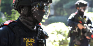Police DHS officers in tactical gear on duty.