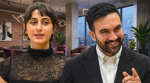 Two professionals engaged in conversation in a modern office setting