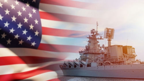 US flag and navy warship in the background.