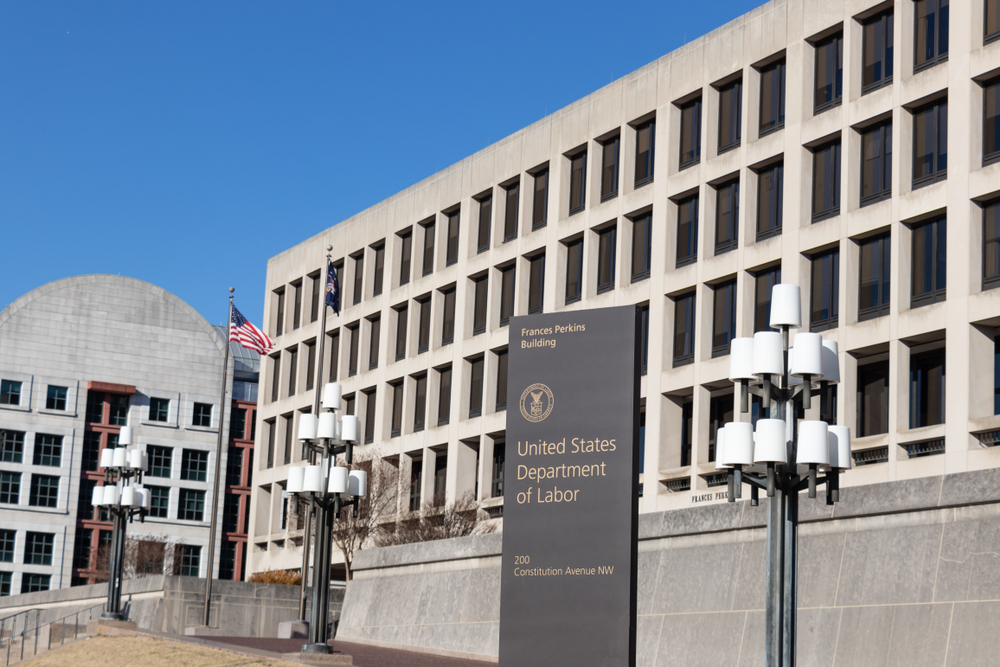 United States Department of Labor building exterior with sign and flags